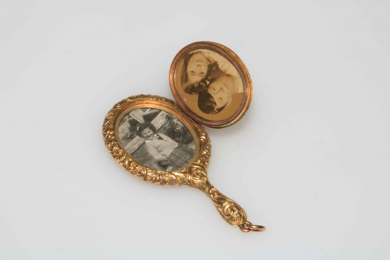 WITHDRAWN                   Gold miniature locket in the form of a hand mirror, bearing registration number 451092.