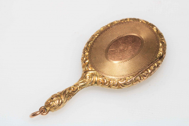 WITHDRAWN                   Gold miniature locket in the form of a hand mirror, bearing registration number 451092.