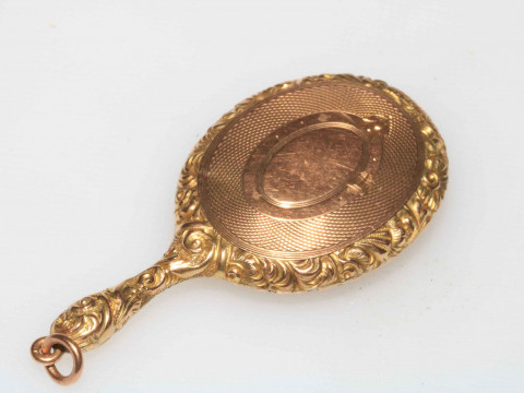 WITHDRAWN                   Gold miniature locket in the form of a hand mirror, bearing registration number 451092. thumbnail