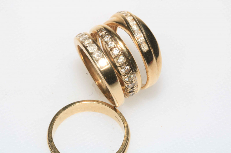Four 9 carat gold ladies rings including diamond.