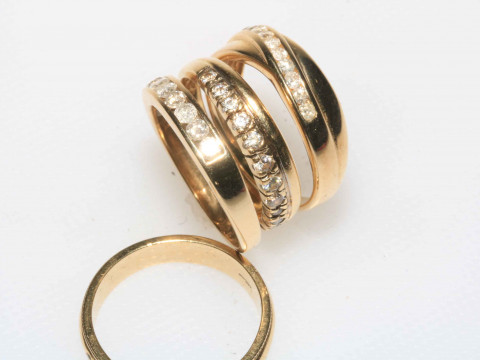 Four 9 carat gold ladies rings including diamond.