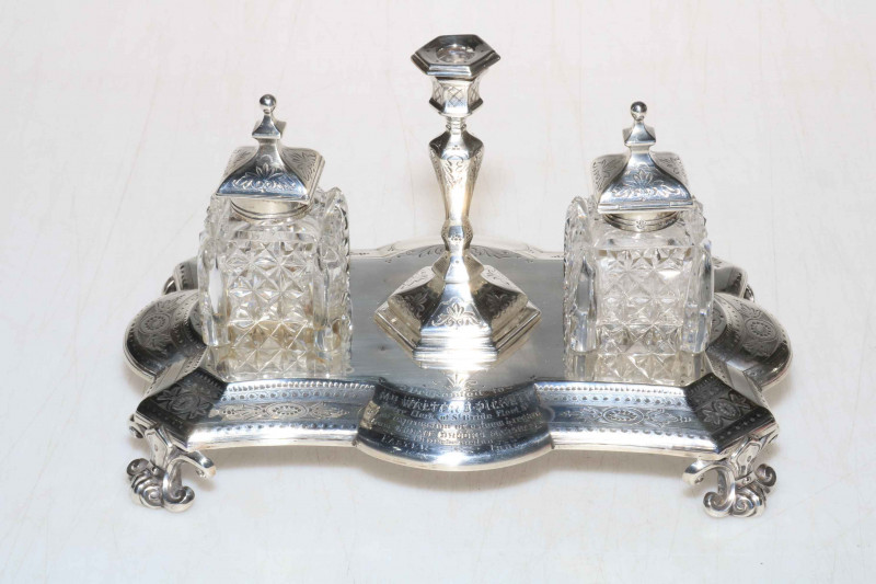 Victorian silver inkstand having engraved decoration and on scroll feet, presented by the church warden at St. Brides, Fleet Street, London 1877, 20cm across.
