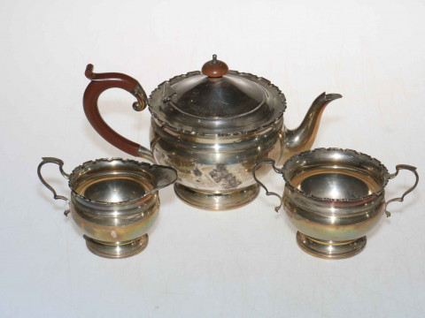 Silver three piece tea service with shaped rims, Birmingham 1927.