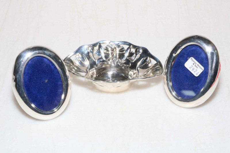 Small silver bowl and pair of oval photograph frames.