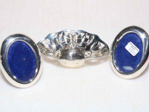 Small silver bowl and pair of oval photograph frames.
