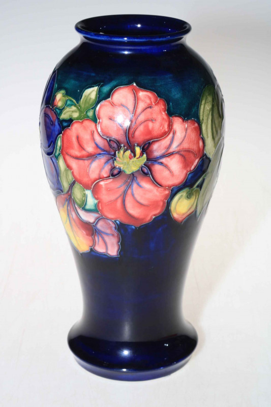 Moorcroft baluster vase decorated with clematis on green ground, 27cm high with box.