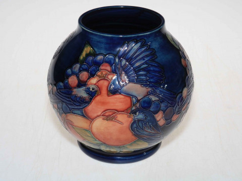 Moorcroft ovoid vase with finches design on blue ground, 19cm high.