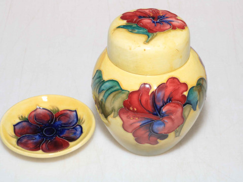 Moorcroft ginger jar decorated with hibiscus design on yellow ground,...