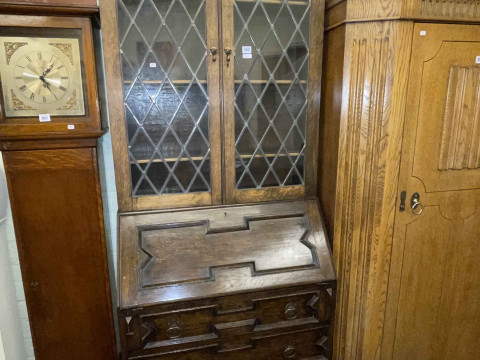 1920's oak bureau bookcase having two leaded glass doors above a fall...