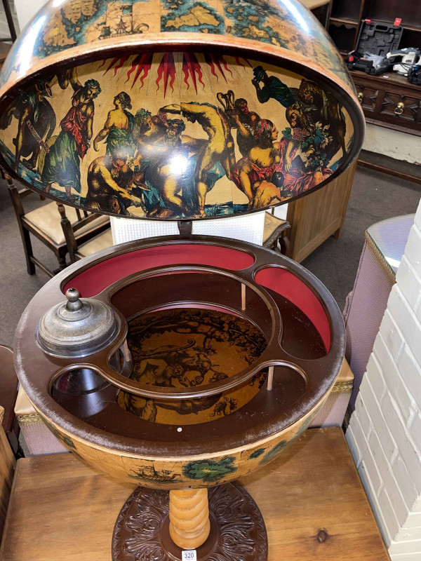 Revolving Latin globe cocktail cabinet on pedestal stand.