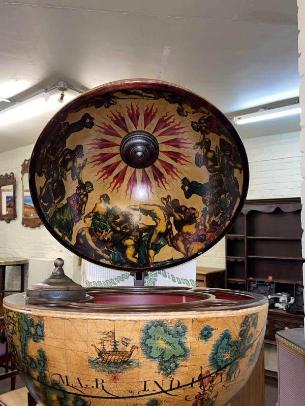 Revolving Latin globe cocktail cabinet on pedestal stand.