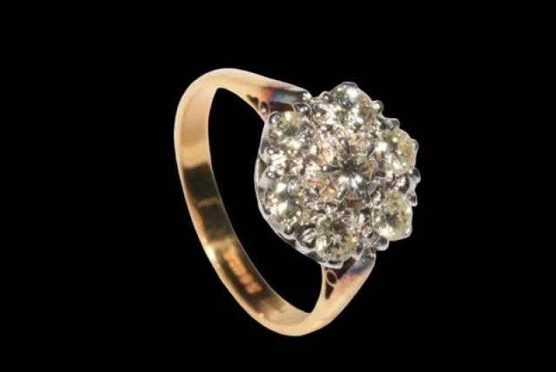 Seven stone diamond petal design ring, the diamonds claw set in white gold to yellow gold shank, size R.