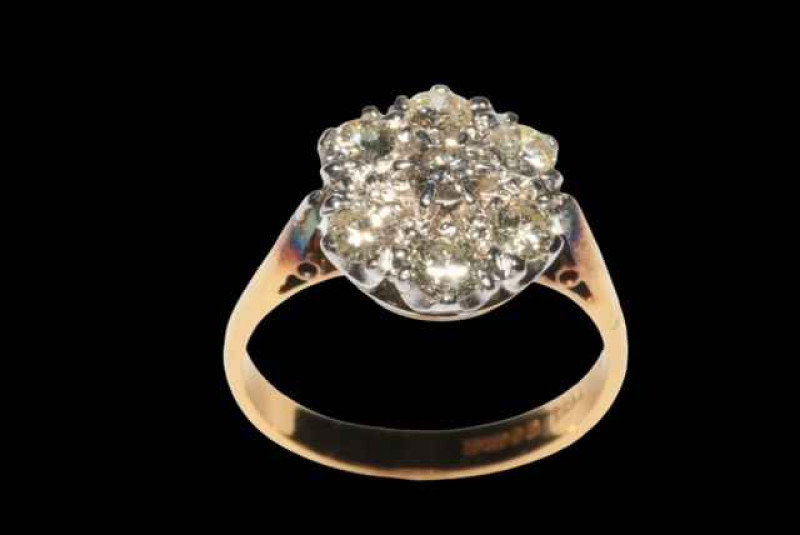 Seven stone diamond petal design ring, the diamonds claw set in white gold to yellow gold shank, size R.