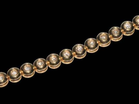 18 carat yellow gold rubover design tennis bracelet with a total of 34 round brilliant cut diamonds, 18cm long. thumbnail