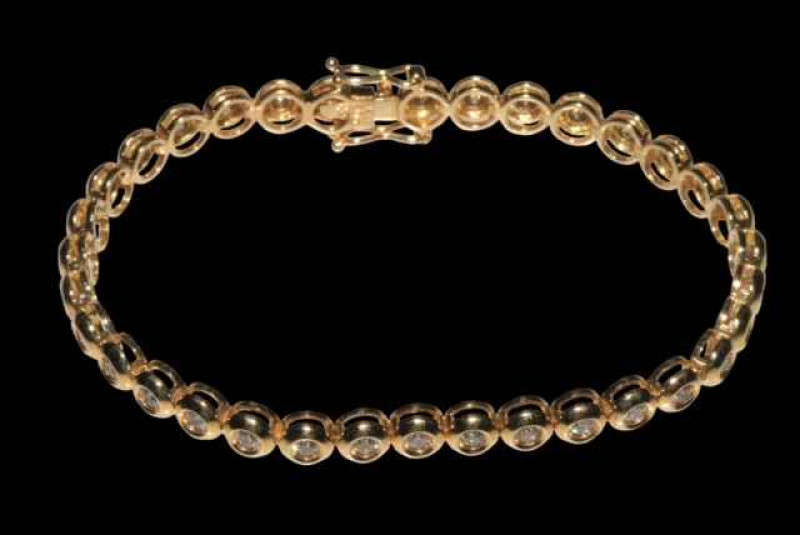 18 carat yellow gold rubover design tennis bracelet with a total of 34 round brilliant cut diamonds, 18cm long.