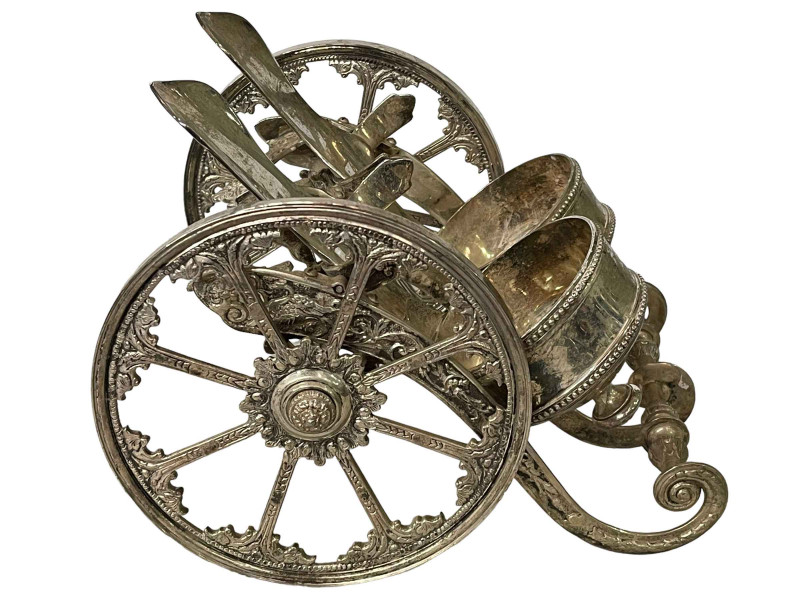 Silver plated double wine bottle chariot, 29cm across.