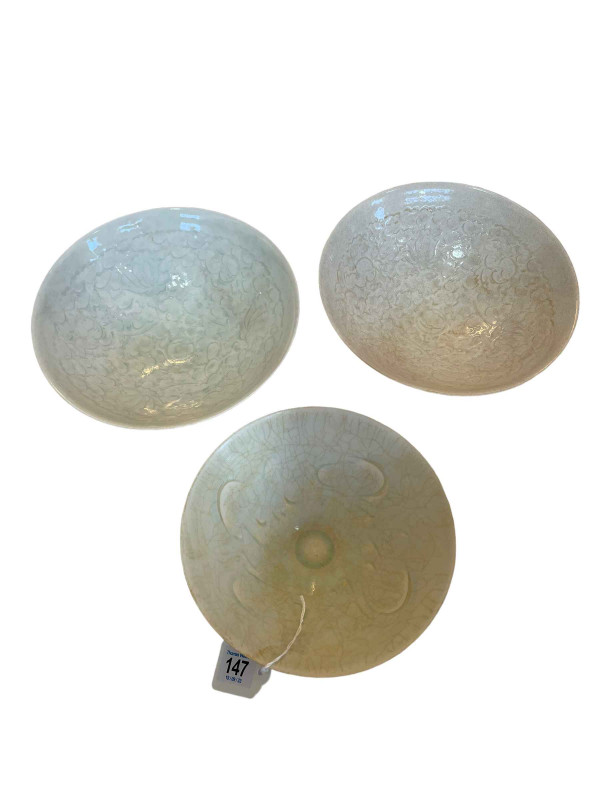 Three Celadon bowls, largest 20cm diameter.