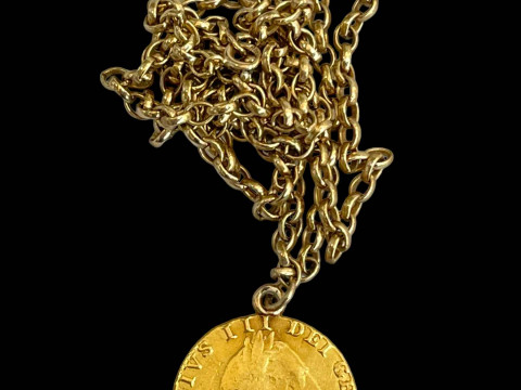 George III gold guinea 1787 on 9 carat gold chain, 60cm length.