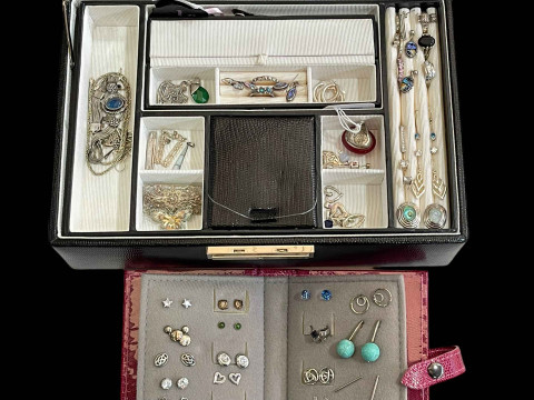Jewellery box with many pieces of silver jewellery.