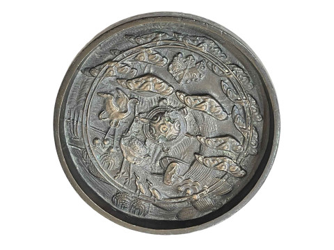 Small Oriental bronze relief plaque, 12cm diameter.