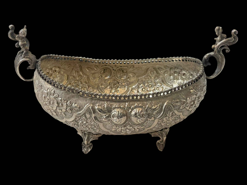 Continental 900 silver bowl with embossed decoration and cherub adorned handles, 27cm across.