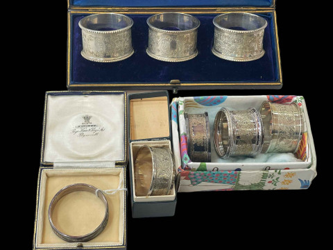 Cased set of three engraved silver napkin rings, Sheffield 1909, together...