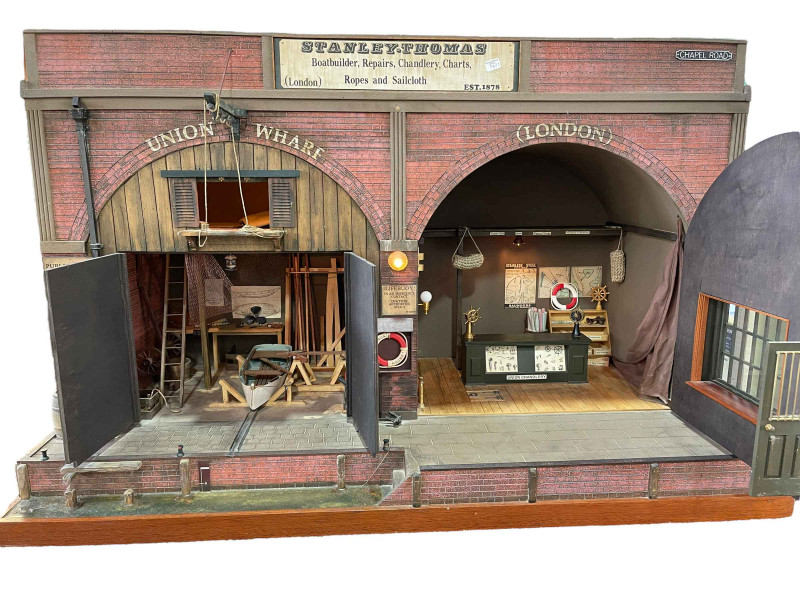 Steve Hilbert, miniature model of a boathouse, with electric lights.