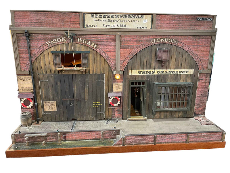 Steve Hilbert, miniature model of a boathouse, with electric lights.
