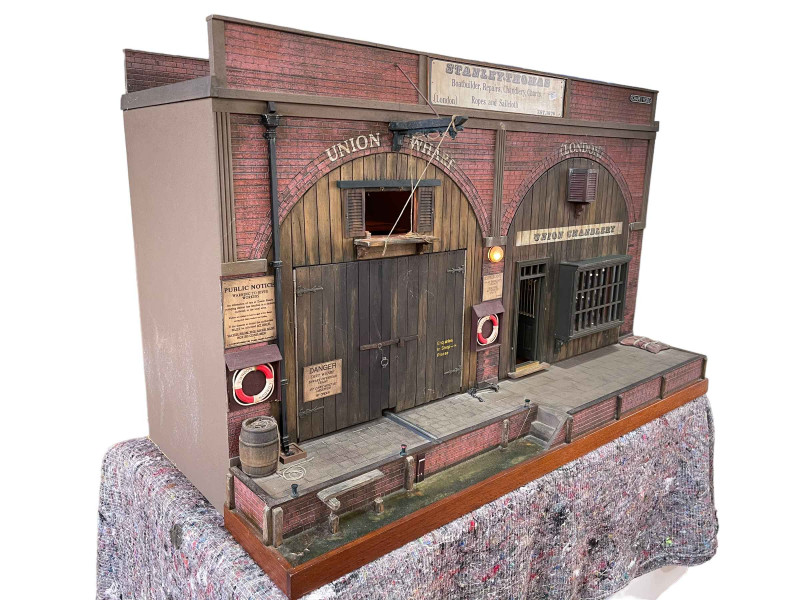 Steve Hilbert, miniature model of a boathouse, with electric lights.