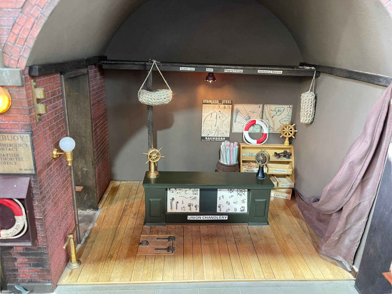 Steve Hilbert, miniature model of a boathouse, with electric lights.