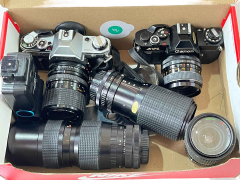 Canon AE1 and AV1 cameras with five lenses.