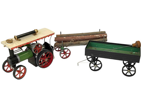 Mamod steam tractor together with open trailer and log trailer.