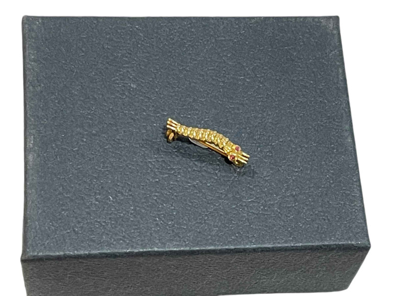 A WWII caterpillar club brooch in gold?, ruby/garnet cabochon set eyes, engraved to the reverse 'P/L. J. P. KELLY', with a secured pin clasp. Pilot unknown, no such record. No certificate.