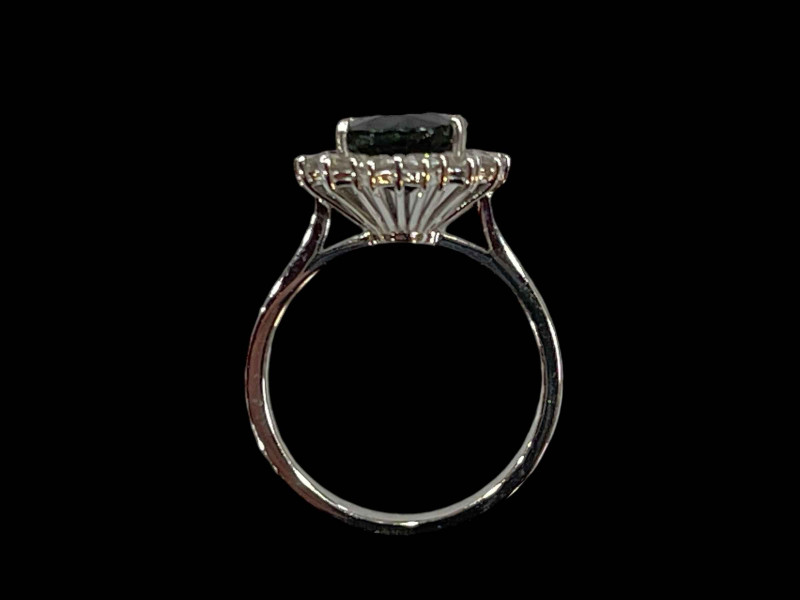 18 carat white gold claw set oval sapphire and diamond cluster ring, sapphire 3.90 carats, diamonds 0.50 carats.