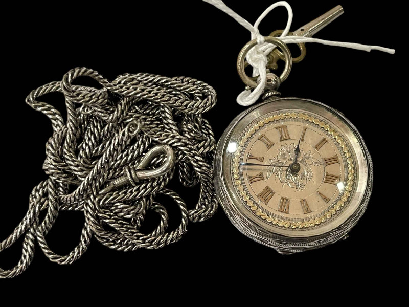 Silver fob watch and large chain.