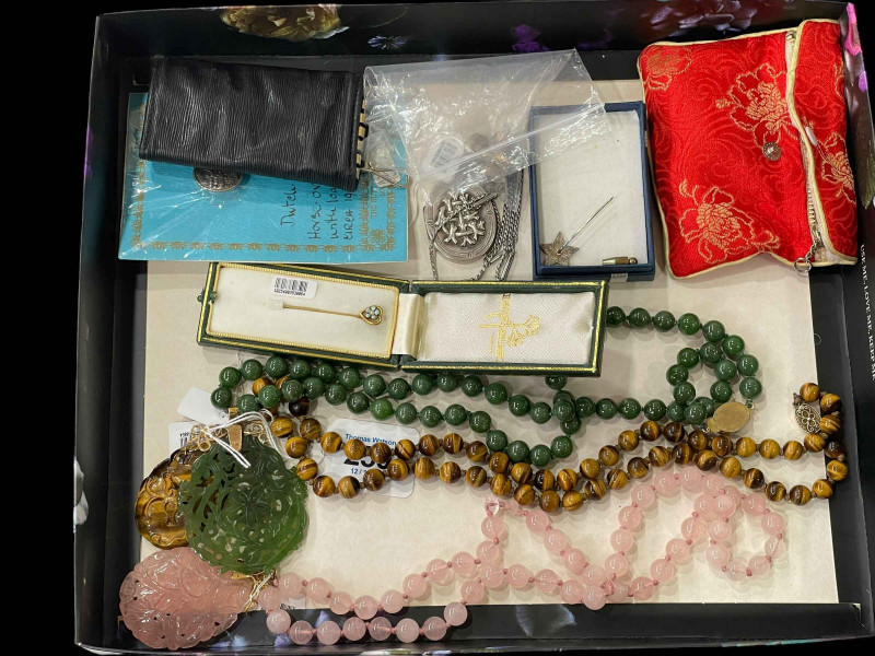Box of assorted jewellery including pendants and necklaces.