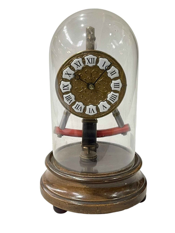 Boule electric clock under glass dome.