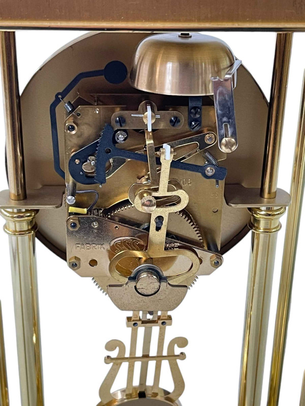 Rapport brass four pillar mantel clock with enamel dial.