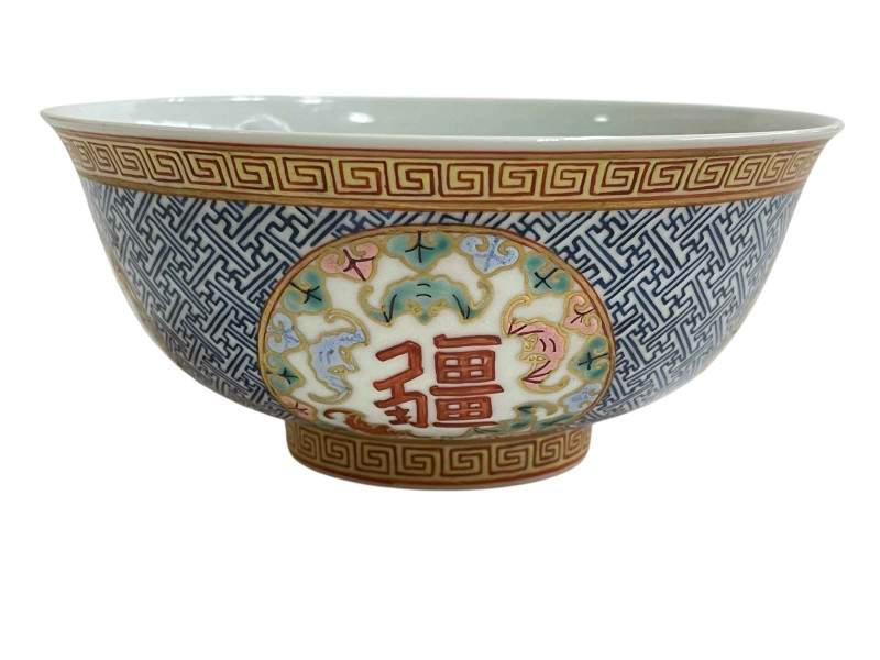Small Chinese bowl with blue and white geometric and floral panel design, red seal mark to base, 15cm.