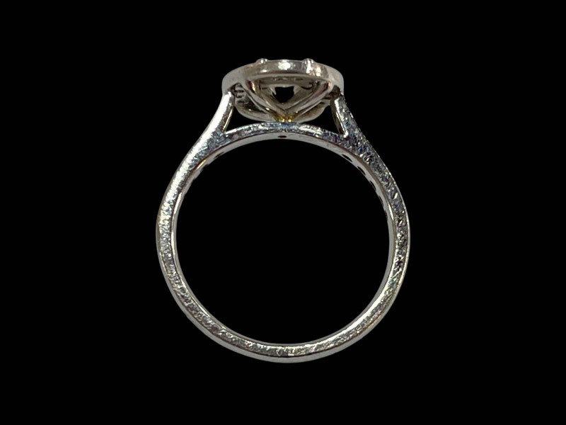Platinum and diamond cluster ring, the central oval diamond 0.48 carats bordered by sixteen brilliant cut diamonds and further fourteen set into the shoulders, total diamond weight 0.90 carats, size K.