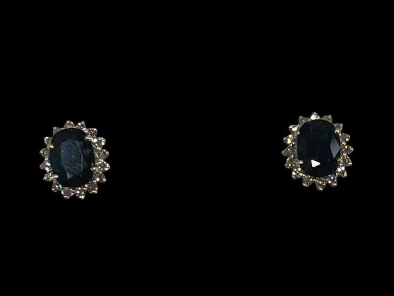 Pair of oval sapphire and diamond cluster earrings set in 18 carat white gold, sapphire 6.65 carats and diamonds 1.02 carats.