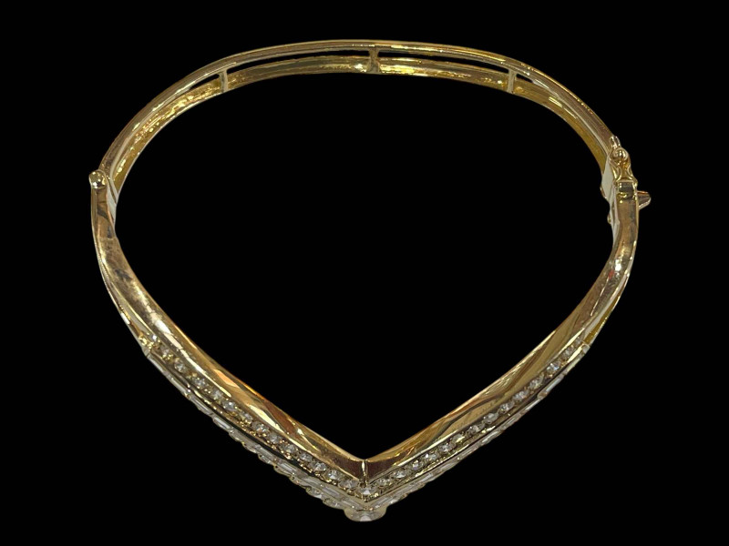 Diamond 'V' shaped bangle set with central row of baguette cut diamonds flanked by rows of brilliant cut diamonds in 18 carat yellow gold, diamonds 3 carats.