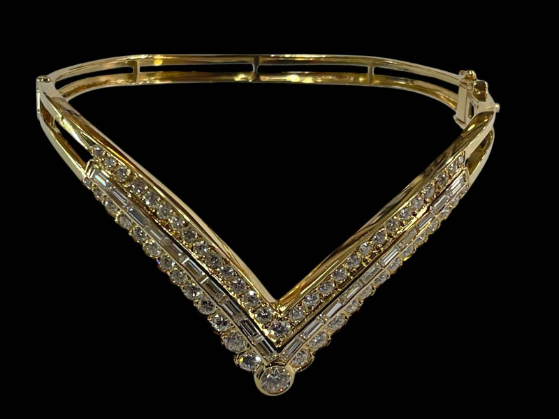 Diamond 'V' shaped bangle set with central row of baguette cut diamonds flanked by rows of brilliant cut diamonds in 18 carat yellow gold, diamonds 3 carats.