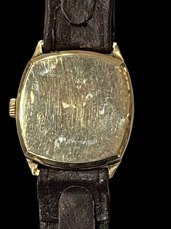 Gold Tudor wristwatch.