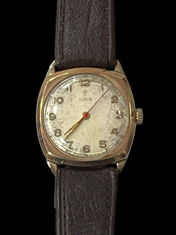 Gold Tudor wristwatch.