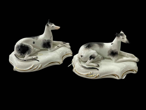 Pair 19th Century porcelain greyhounds, 13cm across.