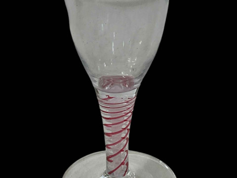Antique ale glass with red twist stem.