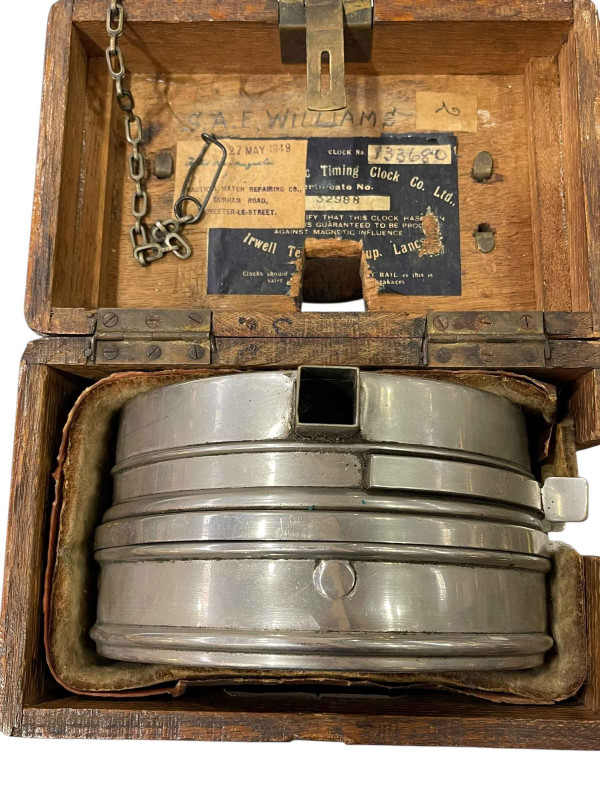 Pigeon timing clock in carrying case, bearing label for repair in May 1949, together with four pigeon racing books.