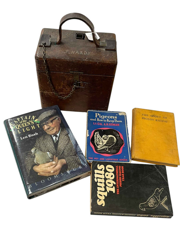 Pigeon timing clock in carrying case, bearing label for repair in May 1949, together with four pigeon racing books.