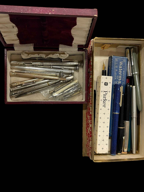 Two boxes of pens and propelling pencils, including silver.
